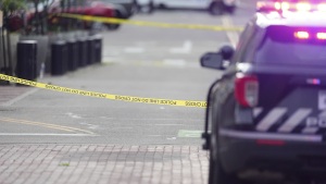 Crime scene tape blocks off the intersection on Pearl Street as law enforcement officials investigate after an attack on the pedestrian mall on Sunday in Boulder, Colo.