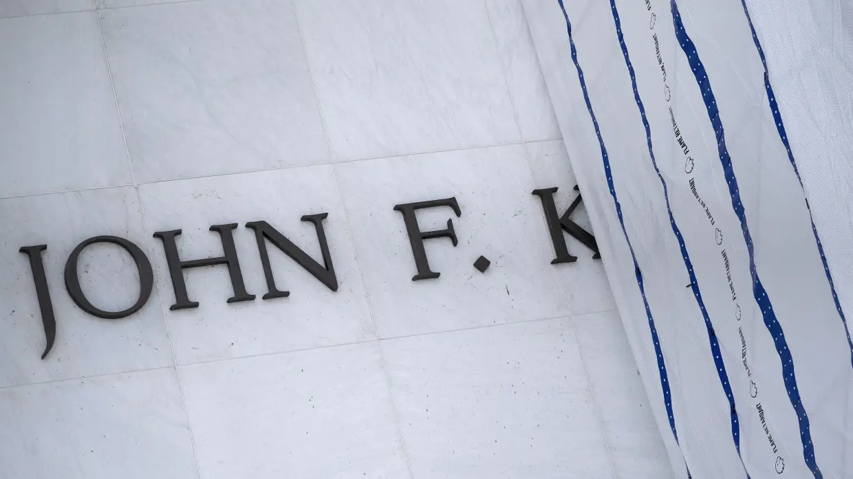 A tarp covers signage on the facade of the Kennedy Center in Washington, D.C, on June 15, 2026, after a judge ordered the removal of President Donald Trump's name.