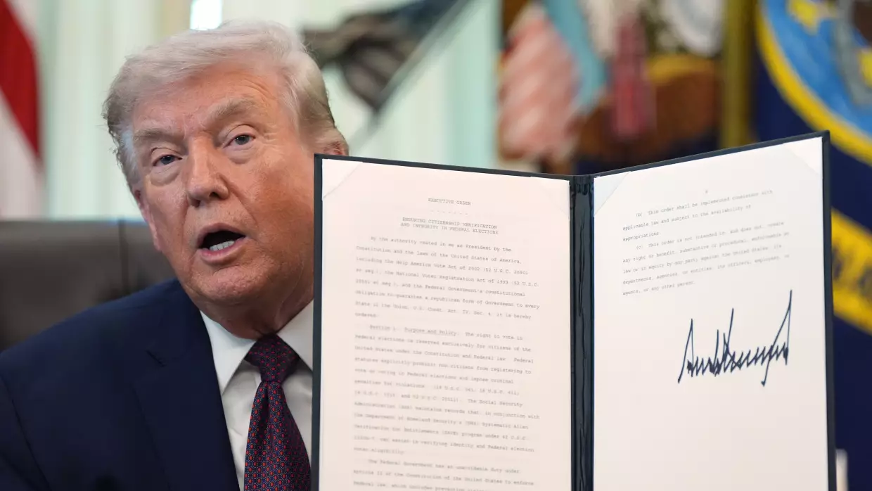 President Trump holds his signed executive order that calls for restricting voting by mail in the White House's Oval Office in March.