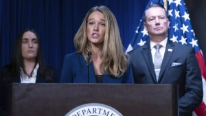 Standing behind a lectern with a microphone attached to it, Tricia McLaughlin, the assistant secretary for public affairs at the Department of Homeland Security, speaks during a news conference at the headquarters of Immigration and Customs Enforcement in May 2025.