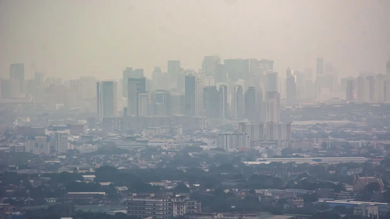 Smog mixed with a thick layer of clouds covers the Metro Manila skyline in the Philippines on Aug. 27.