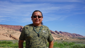 Raymond Peaches stands near where one proposed hydropower project might one day sit on the Navajo Nation. Critics of the project point to questionable tactics used by the developer and his allies as they advocate for the facility.