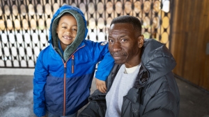 Seven-year-old Khalib Townsend poses with conservation biologist Keith Russel at the Audubon Discovery Center in Philadelphia.