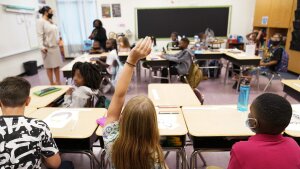 A student raises their hand in a classroom at Tussahaw Elementary school Aug. 4, 2021, in McDonough, Ga. 