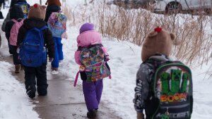 Students walk from a bus at a St. Paul School District elementary school in St. PaulMinnesotaU.S.March 182026.