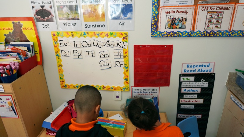 Students help put away supplies at the end of a reading and writing lesson at a Head Start program in Miami in January 2025.