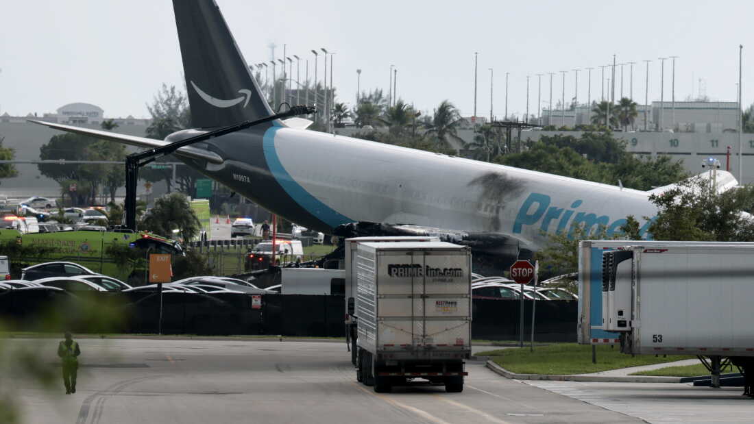 An Amazon cargo plane is seen after it crashed at Miami International Airport on Sunday in Miami, Florida. The Federal Aviation Administration said Prime Air Flight 7598 overran the runway while landing around 2 p.m. ET after departing from San Juan, Puerto Rico.