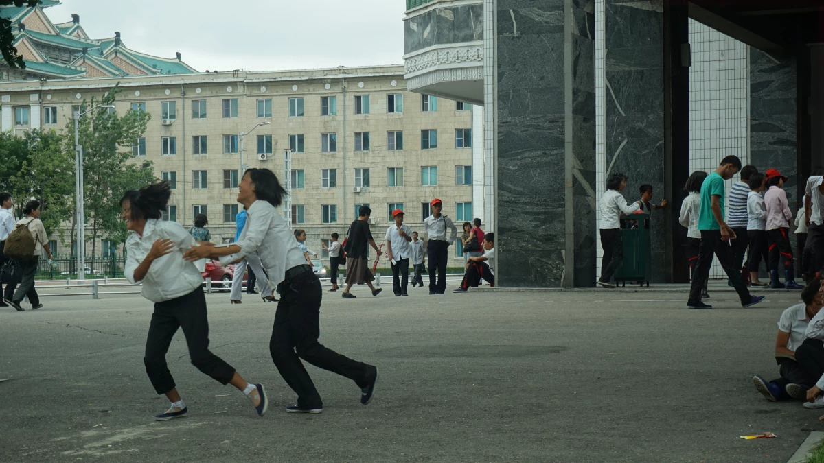 Two kids play in Kim II Sung Square.