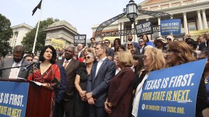 Texas state Senator Carol Alvarado, a Democrat, speaks in a crowd of other Democratic state lawmakers outside the Massachusetts State House on Wednesday, Aug. 6, 2025 in Boston.