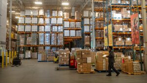 An employee walks past pallets of nonperishable food at a warehouse of the Capital Area Food Bank in Washington, D.C., on Nov. 6.