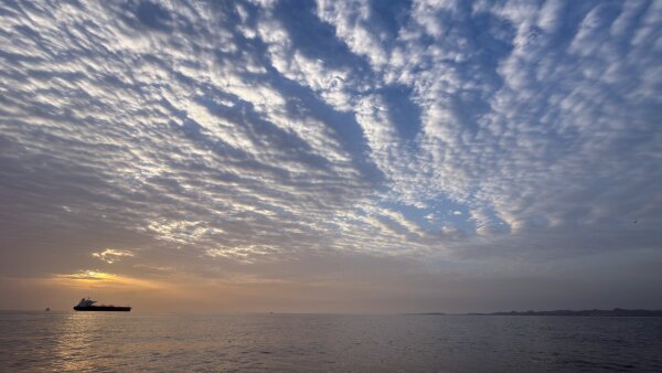The sun rises behind a tanker anchored in the Strait of Hormuz off the coast of Qeshm Island, Iran, on Saturday. 