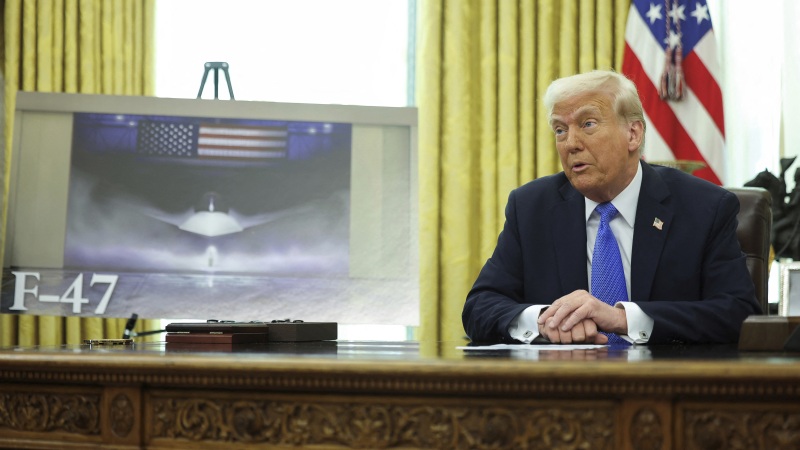President Trump speaks as an image of an F-47 fighter jet is displayed in the Oval Office in Washington on Friday.