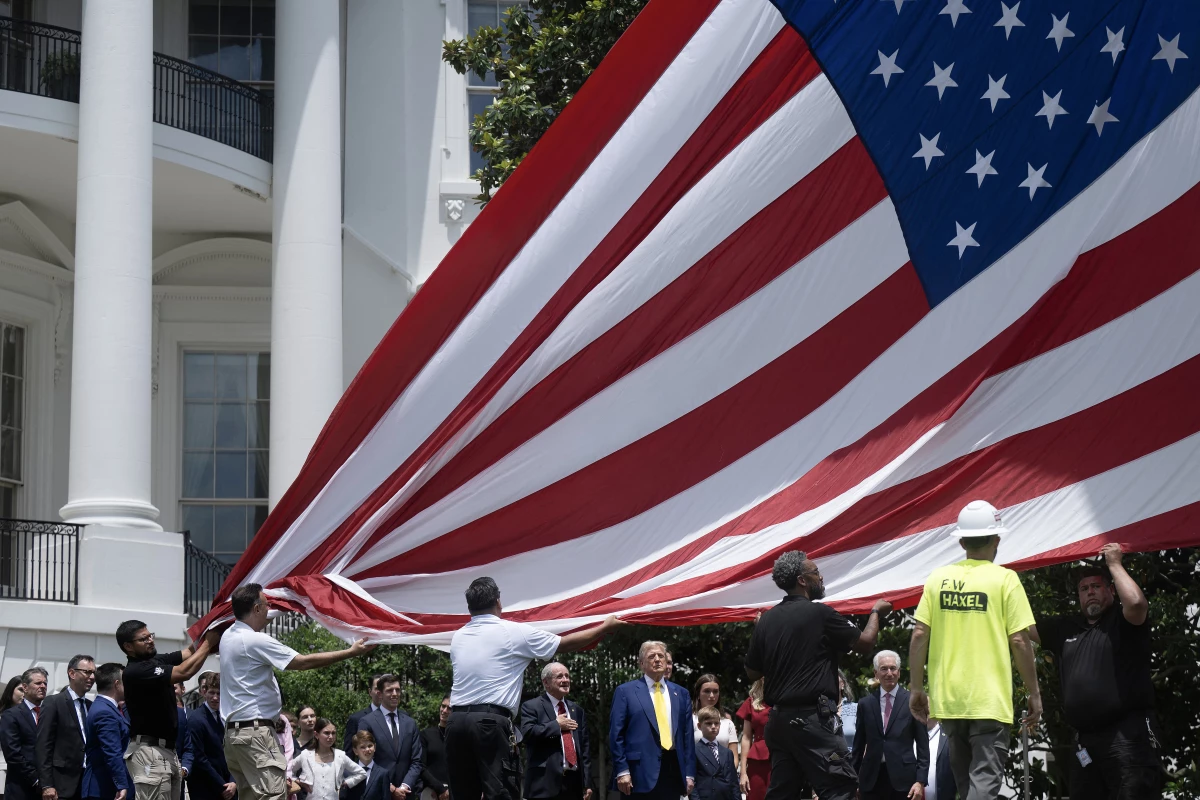 President Trump watches as the flag is raised on a new flagpole on the South Lawn of the White House on June 18, 2025.