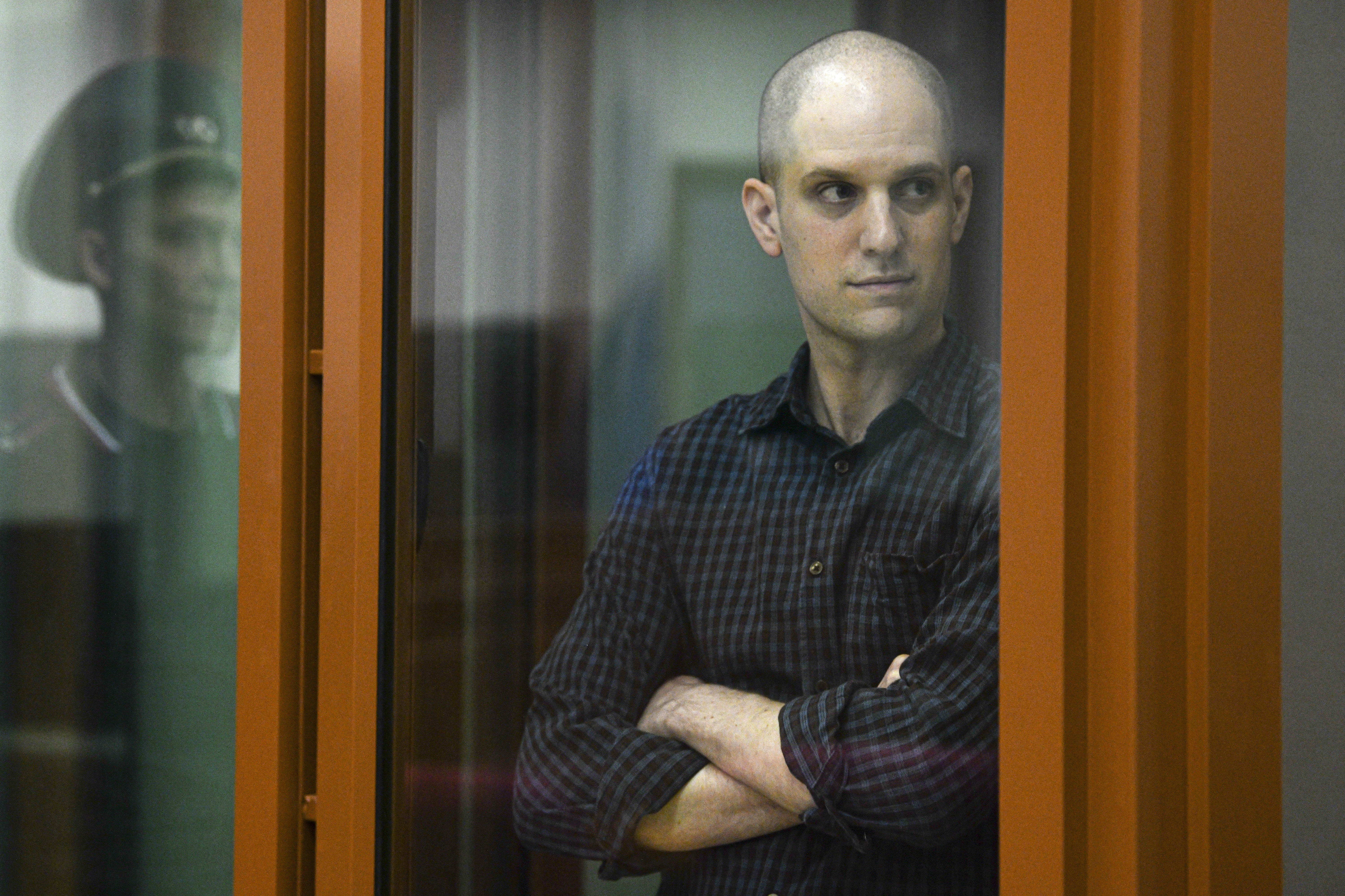 <em>Wall Street Journal </em>reporter Evan Gershkovich stands in a glass cage in a courtroom in Yekaterinburg, Russia, June 26.