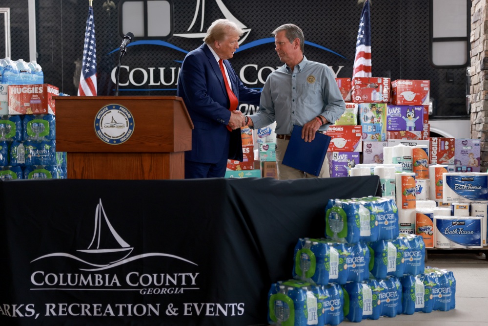 Republican presidential nominee, former President Donald Trump, and Georgia Gov. Brian Kemp shake hands as they visit the area while it recovers from Hurricane Helene on Oct. 04 in Evans, Ga. (Getty Images)