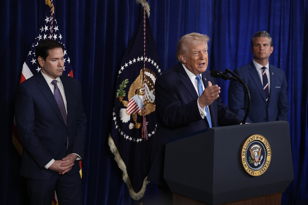 Secretary of State Marco Rubio and Secretary of Defense Pete Hegseth listen as President Trump addresses the media during a news conference at his Mar-a-Lago club on Saturday in Palm Beach, Fla. (Getty Images)