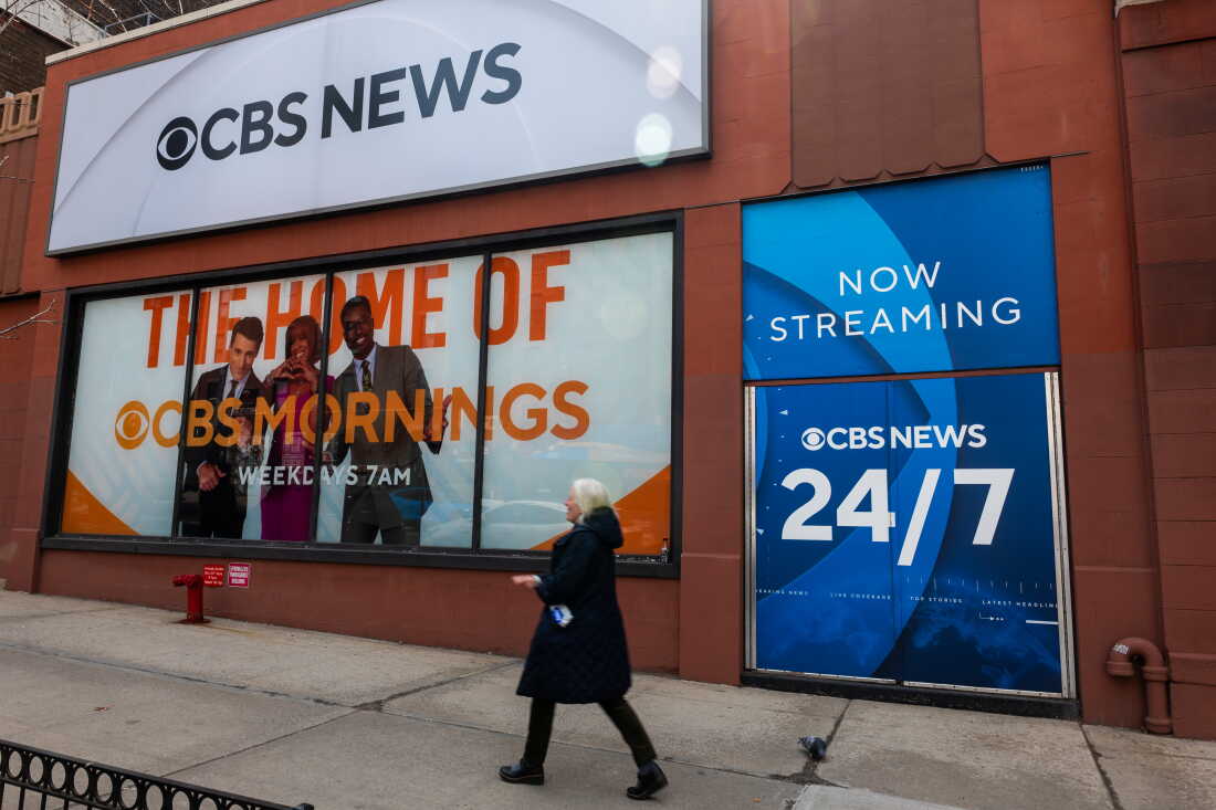 People walk by the CBS Broadcast Center in Manhattan on March 20, 2026 in New York City. CBS News and CNN are merging as part of the Paramount and Warner Bros. acquisition.