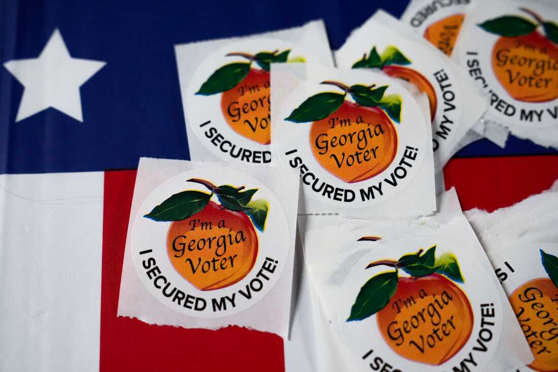 In this file photo, stickers featuring a peach with the words "I'm a Georgia voter" and "I secured my vote" sit on a table inside a polling place on Nov. 5, 2024, in Atlanta.