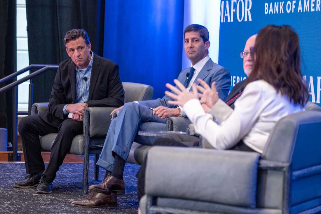 Kevin Warsh (center) is President Trump's pick to lead the Federal Reserve. Warsh is a former Fed governor who has echoed the president's call for lower interest rates.