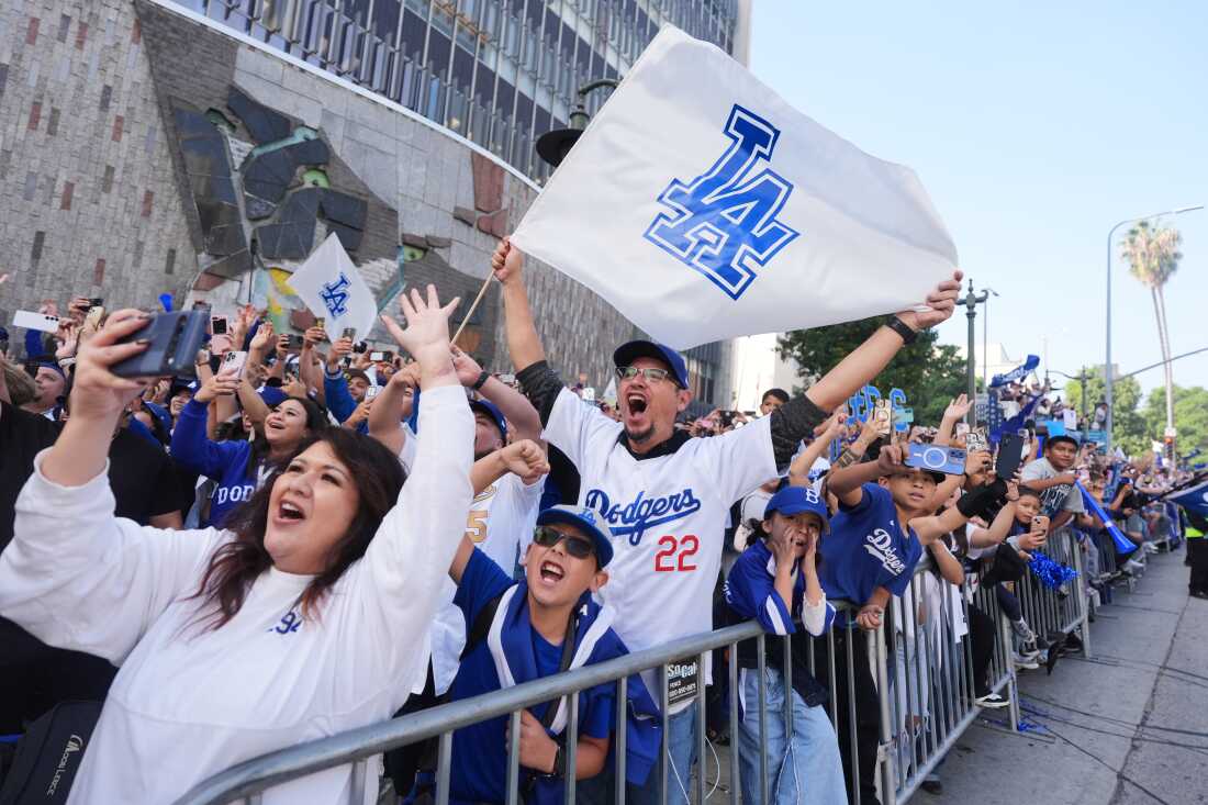 Fans cheer along the route during a parade to celebrate the Los Angeles Dodgers baseball team's World Series win on Monday, Nov. 3, 2025, in Los Angeles, Calif.