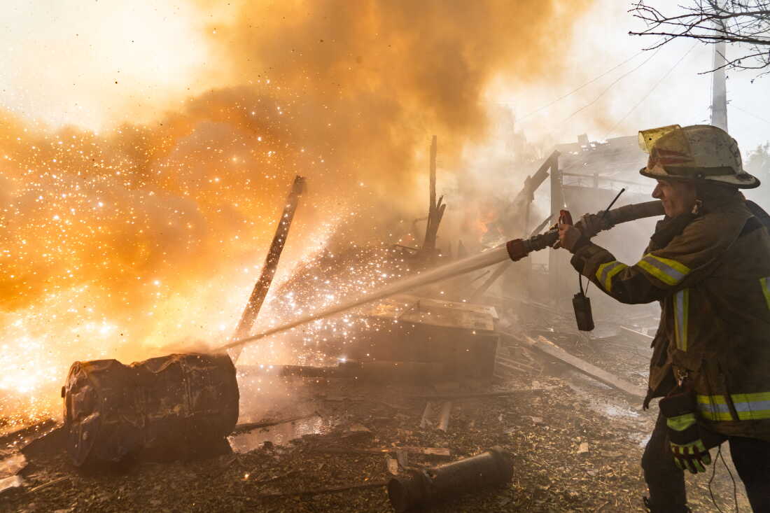 A rescue worker puts out a fire at residential houses destroyed in a Russian strike on Kharkiv, Ukraine, Sunday, Oct. 11, 2026.