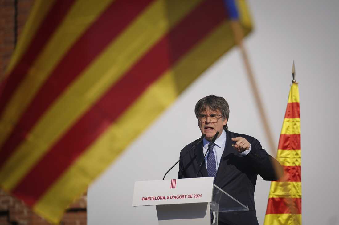 Catalan independence leader and former President Carles Puigdemont addresses supporters after arriving near the Catalan Parliament to attend the inauguration debate in Barcelona, ​​Spain, Thursday.