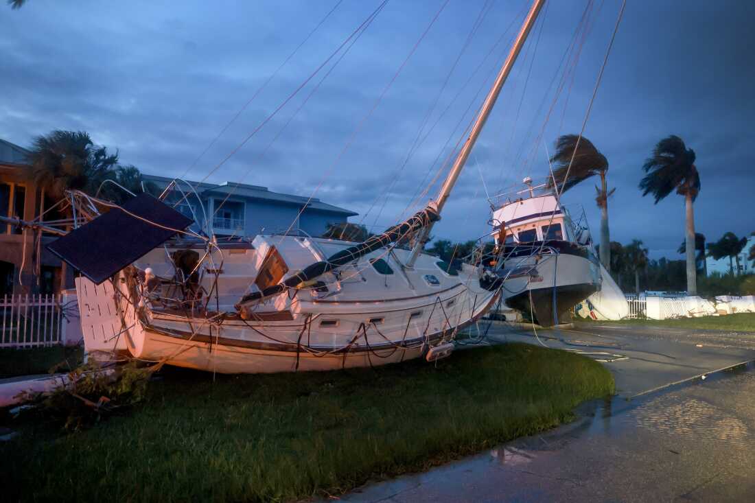 Boats rest in a yard after they were washed ashore when Hurricane Milton passed through the area in Punta Gorda, Florida. The storm made landfall as a Category 3 hurricane in the Siesta Key area of Florida, causing damage and flooding throughout Central Florida.