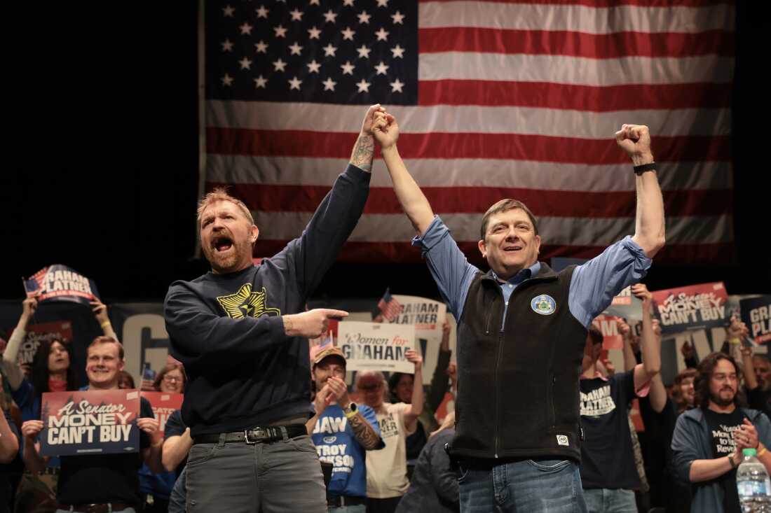 Democratic U.S. Senate candidate Graham Platner and Troy Jackson (R) stand together during a “Fighting Oligarchy” tour stop at the Collins Center for the Arts on the University of Maine campus on May 24 in Orono, Maine.