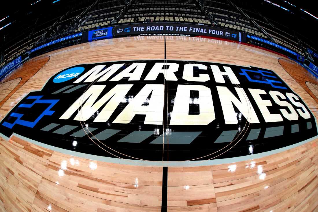 FILE - March Madness logo sis displayed at center court during the opening rounds of the NCAA college basketball tournament in Pittsburgh, Wednesday, March 20, 2024.