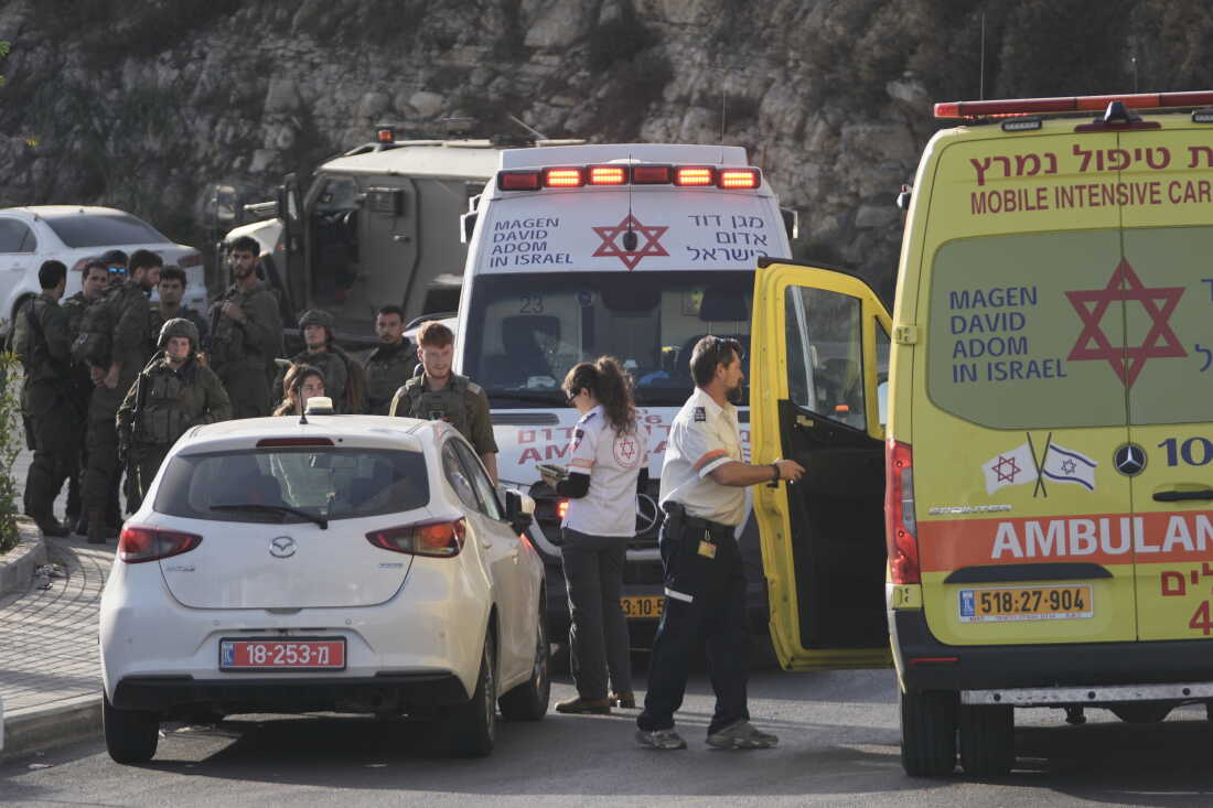 Israeli soldiers and emergency personnel gather near ambulances following a shooting attack near Yehuda Junction, near Hebron, in the occupied West Bank, Friday, Oct. 23, 2026.