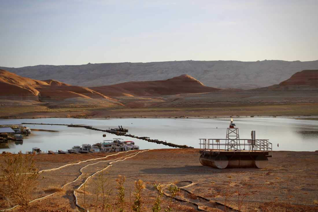 Docks and buoys, once floating atop dozens of feet of water, sit stranded on the shores of Lake Powell on April 9, 2023. President Donald Trump paused funding that was designed to help conserve water and boost the nation’s largest reservoirs.