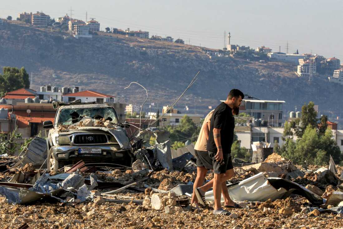 People inspect the site of an Israeli air strike in Jiyeh along the highway linking Beirut to the southern city of Sidon on Sep. 25, 2024. In south Lebanon, a stronghold of Hezbollah, Israeli warplanes bombed villages for a third day on Sep. 25, after air raids earlier this week killed at least 558 people in the deadliest day of violence since the 1975-1990 civil war.