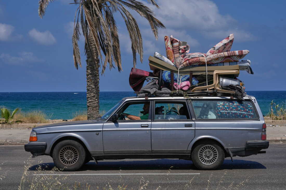 A displaced family with their belongings return to their village following a ceasefire between Israel and Hezbollah in the southern port city of Sidon, Lebanon, Tuesday.