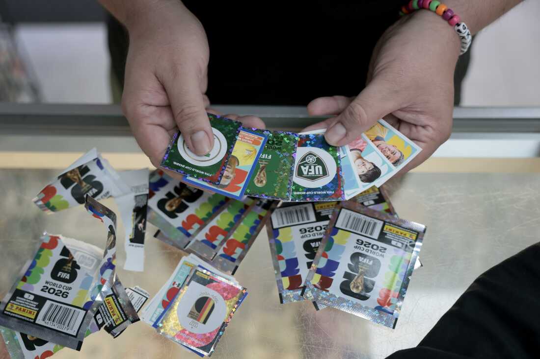 A sticker enthusiast shows off some of the FIFA World Cup 2026 Panini stickers bought at the Soccer Locker on June 2 in Miami.