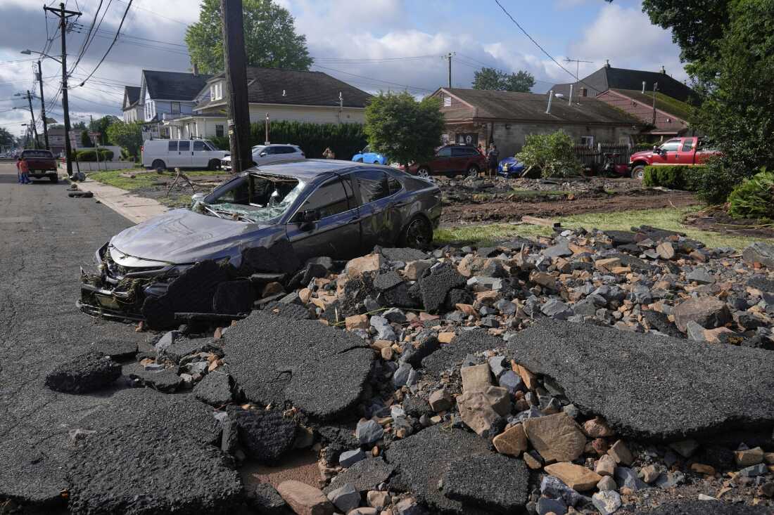 Debris, rubble and a damaged car in North Plainfield, N.J. on Tuesday, July 15, 2025 after flooding from heavy rains in the area. Climate change is causing heavier rain across the United States.