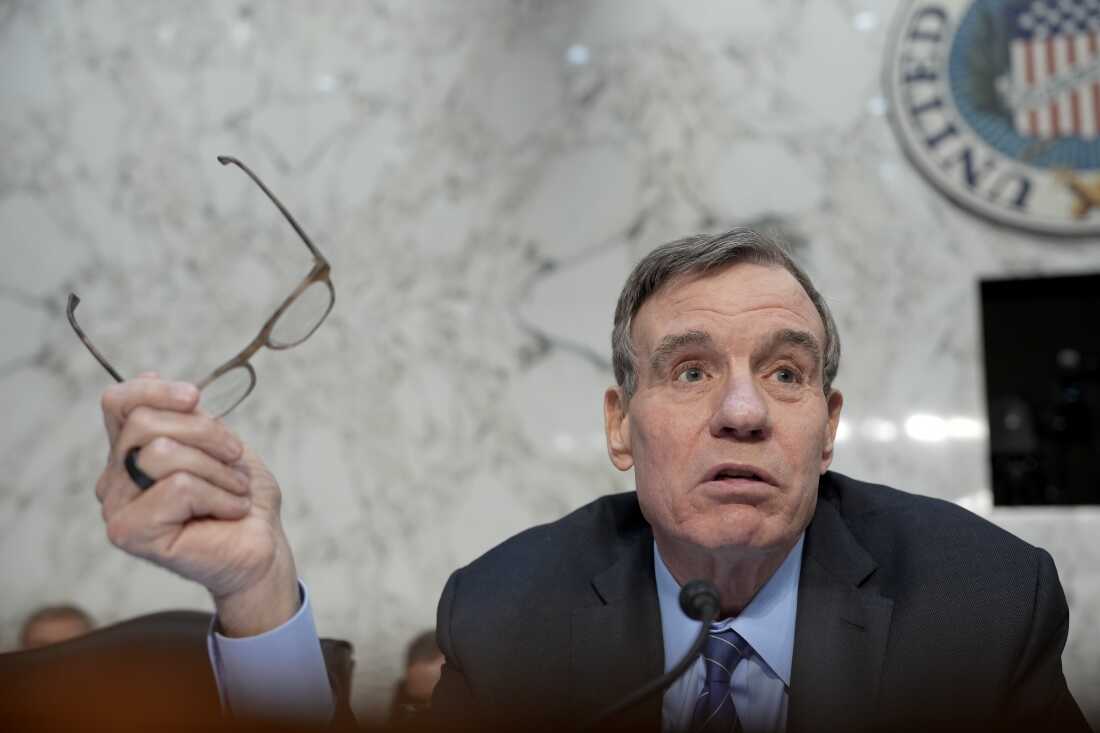 Sen. Mark Warner (D-VA) addresses the nation's top intelligence officials as they appear during a Senate Intelligence Committee hearing on Tuesday.