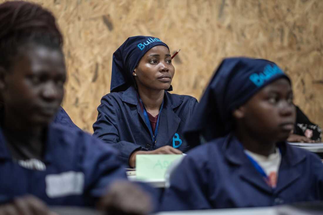 Students listen to their teacher in class at the Buildher Academy in Nairobi, Kenya.