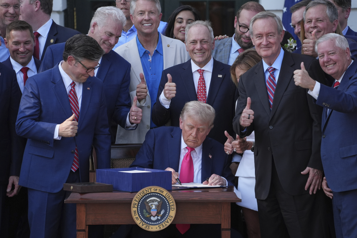 President Trump signs his signature bill of tax breaks and spending cuts at the White House on July 4.