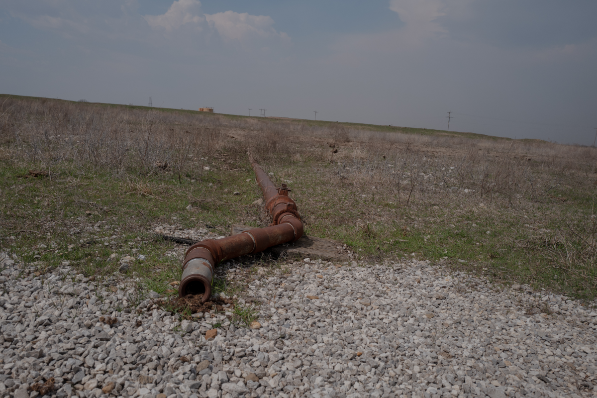 A pipe, left over from a now-defunct piece of oil equipment, stretches across the land in the Tallgrass Prairie Preserve in Oklahoma on March 20, 2024.