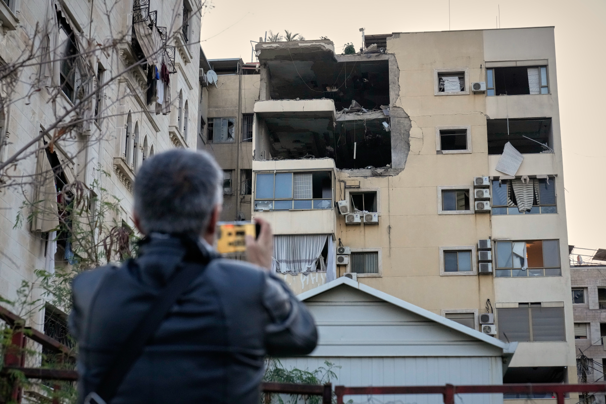 A man takes pictures of the damage in an apartment building after it was hit by an Israeli airstrike in Dahiyeh, Beirut's southern suburb, Lebanon, Monday, March 2, 2026.