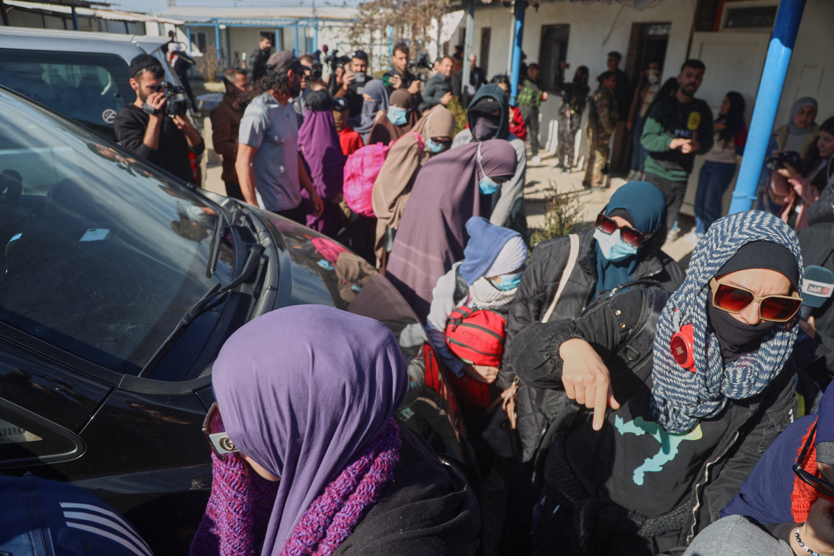 Family members of suspected Islamic State militants who are Australian nationals walk toward a van bound for the airport in Damascus during the first repatriation operation of the year at Roj Camp in eastern Syria, Monday, Feb. 16, 2026. Thirty-four Australian citizens from 11 families departed the camp.