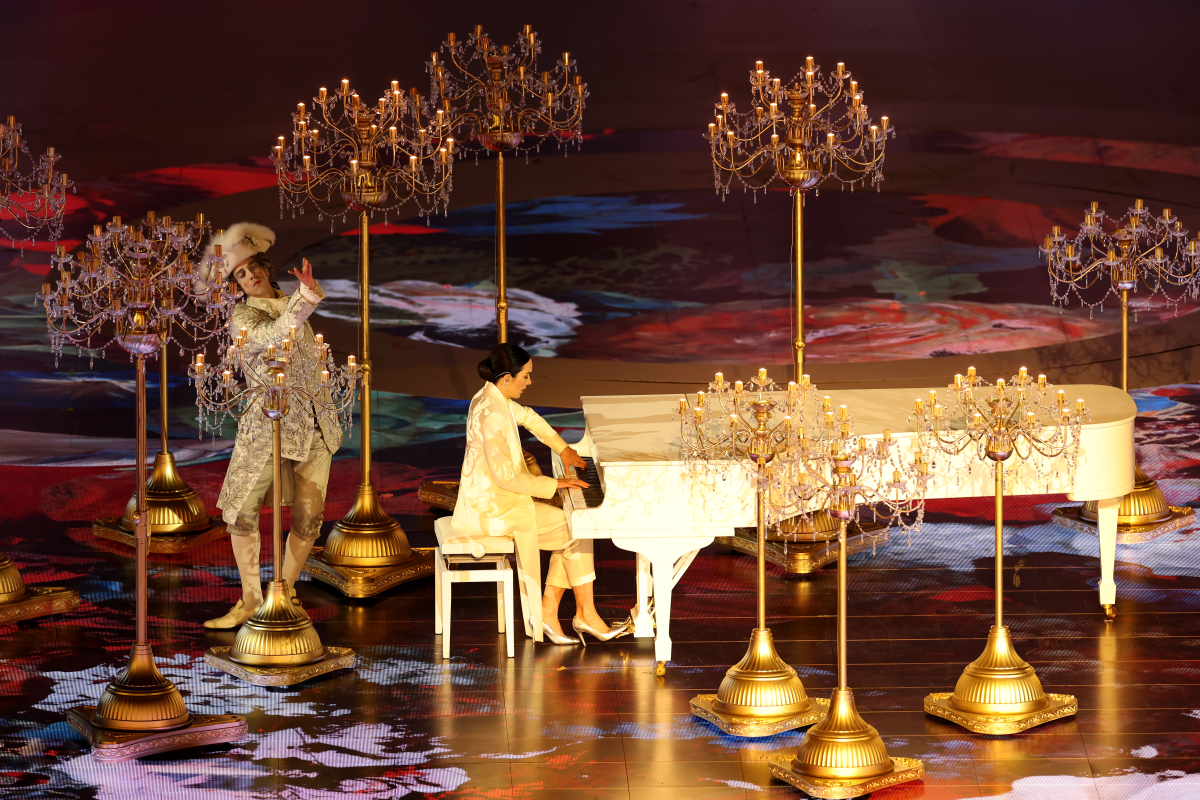 Gloria Campaner plays the piano, surrounded by candelabras, at Sunday's closing ceremony.