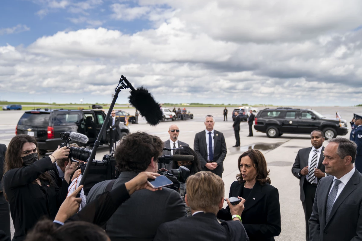 Kamala Harris, shown here as vice president in 2022, speaks to the traveling press pool as second gentleman Doug Emhoff looks on, under the wing of Air Force 2 at Buffalo-Niagra International Airport.