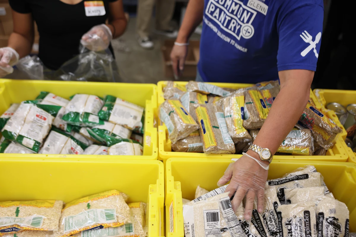 Volunteers with New York Common Pantry help to prepare food packages Wednesday in New York City. Across the country, food banks and food pantries are preparing for a potential surge of people needing food as federal SNAP payments are set to be suspended on Saturday due to the federal government shutdown.