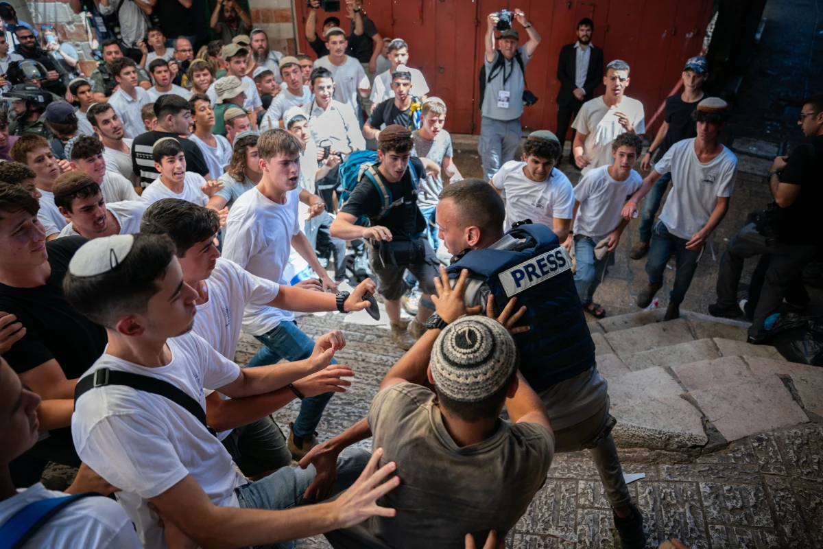 Israeli ultra-nationalist youth attack a Palestinian journalist ahead of the march in the Muslim Quarter of the Old City of Jerusalem.