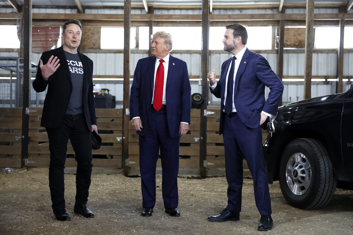 From left: Elon Musk, Republican presidential nominee Donald Trump and his running mate, Sen. JD Vance, talk to reporters backstage during a campaign rally on Oct. 5 in Butler, Pa.