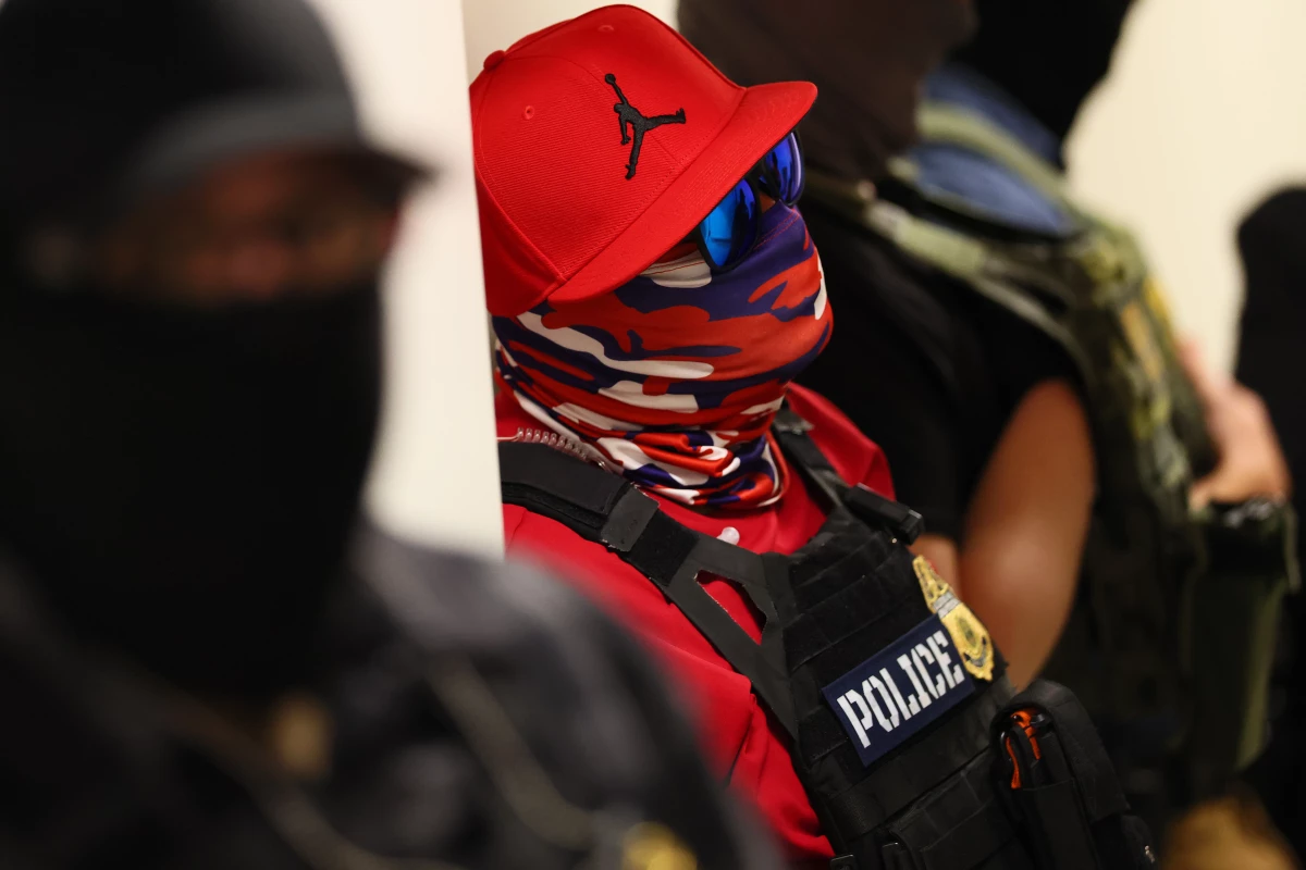 Federal agents wearing masks patrol the halls of the immigration court at the Ted Weiss Federal Building in New York City on July 9.