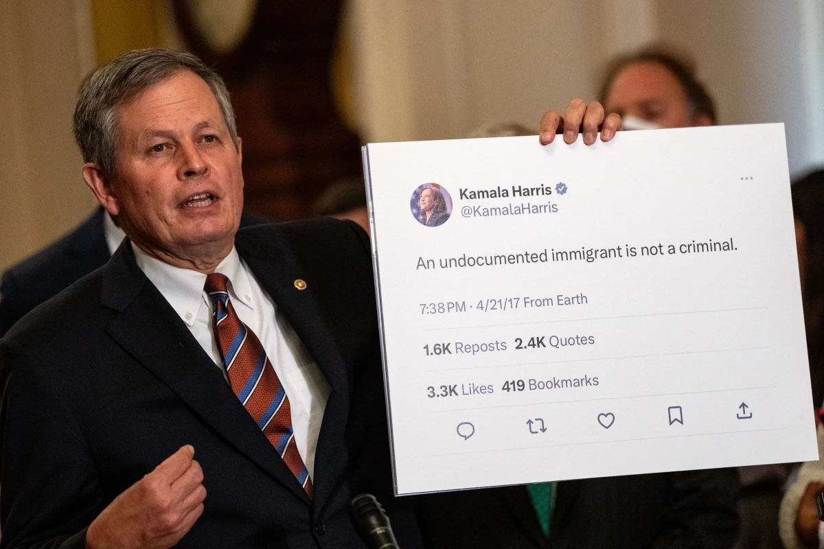 Sen. Steve Daines, R-Mont., holds up a tweet by Vice President Harris at a news conference at the Capitol on July 30, 2024.