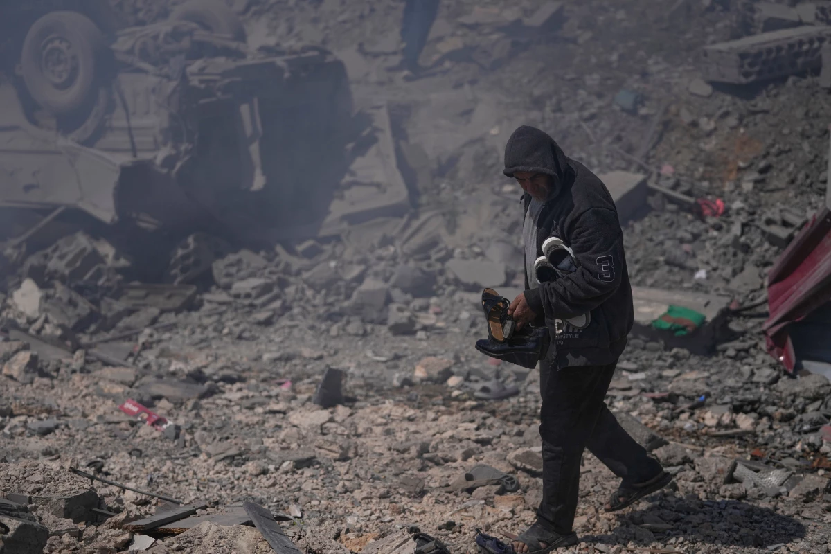 March 8: A man carries shoes from his house, which was destroyed when Israeli airstrikes hit several houses in Sir al-Gharbiyeh village, south Lebanon.