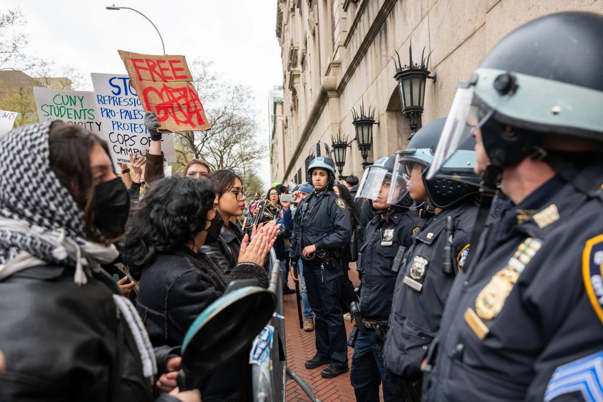 Students and pro-Palestinian activists face police outside of Columbia University to protest the university's stance on Israel on April 18, 2024, in New York City. The protests come after numerous students were arrested earlier in the day after setting up tents on the university lawn in support of Gaza.